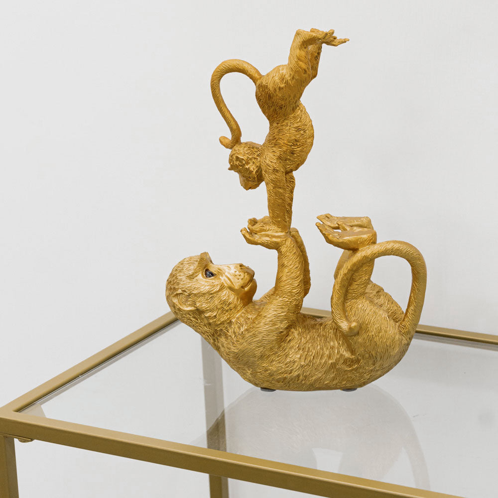 Balancing monkeys in gold resin